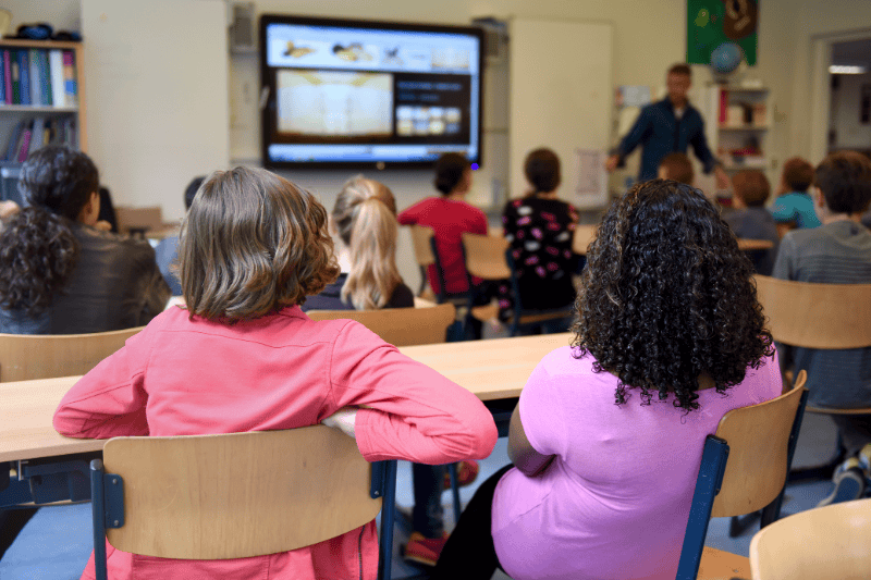 Students attending their first day at a New Jersey real estate school, listening to an instructor and preparing for their licensing course at Garden State Real Estate Academy.